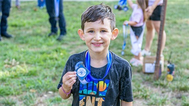 Boy holding medal