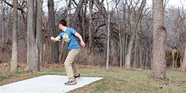 man launching disc from teepad