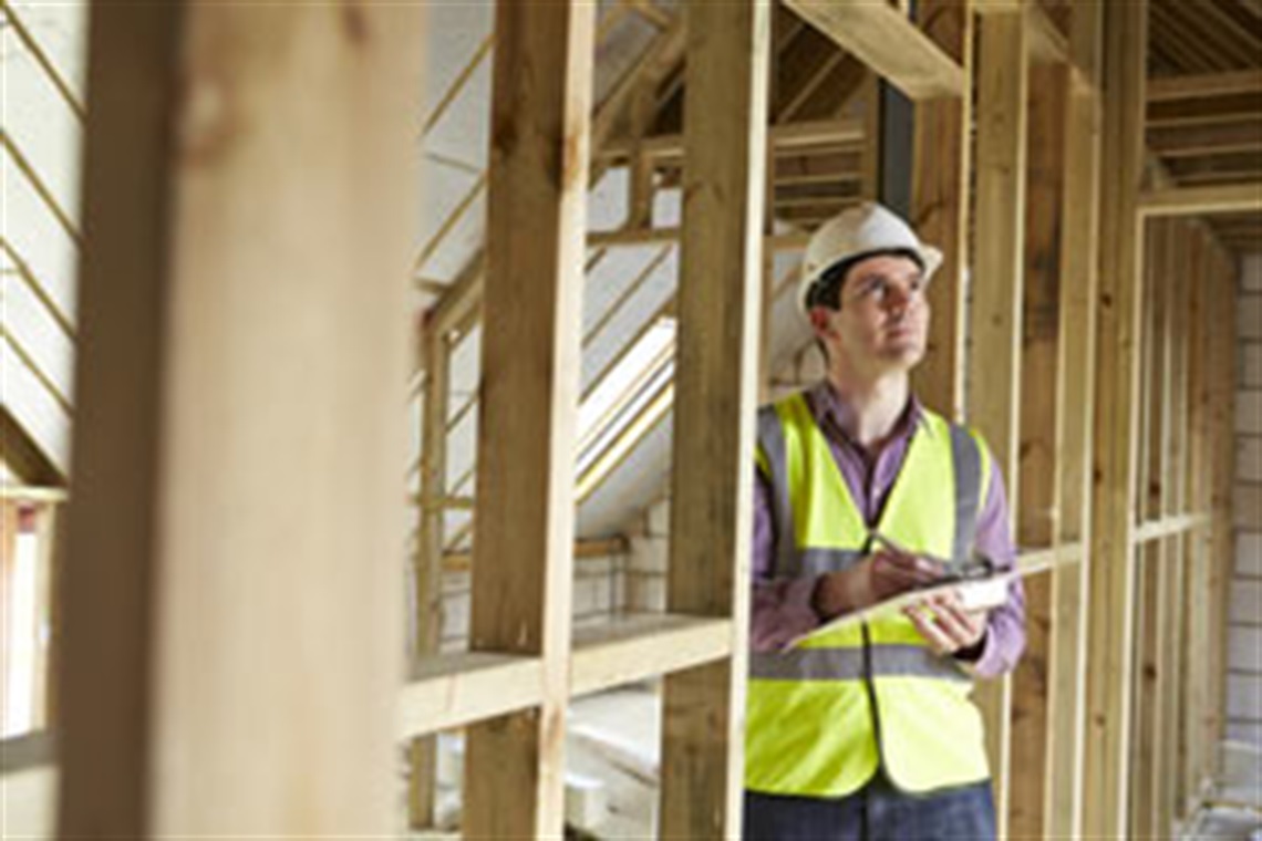 Man looking at framing on a construction site