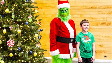 A grumpy guest poses with a boy