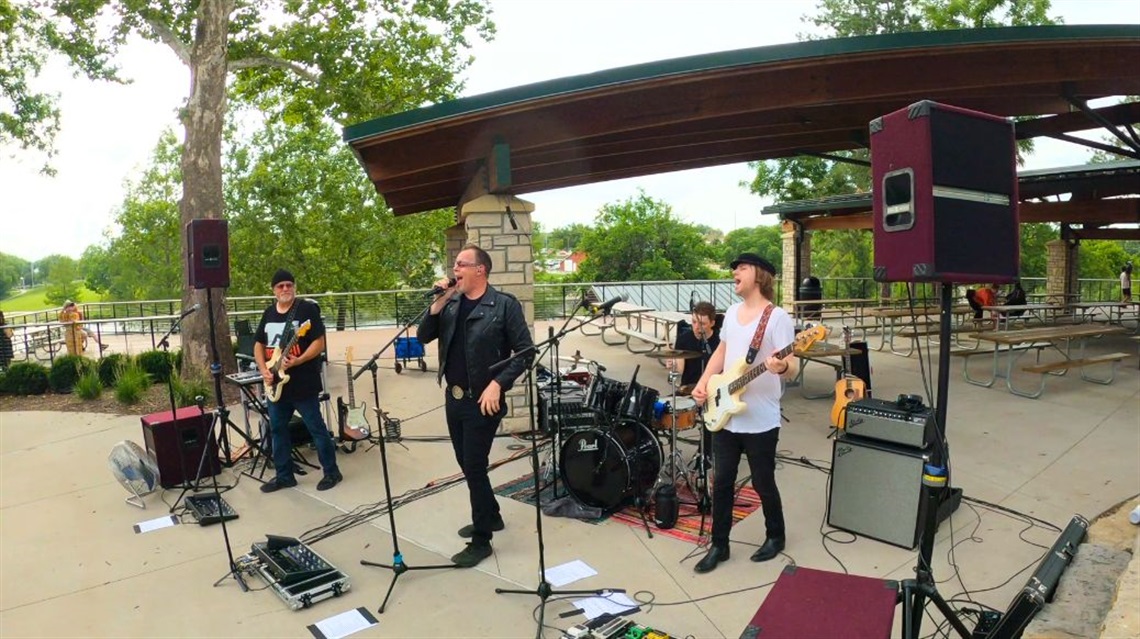 The Joshua Tree performing outside in park