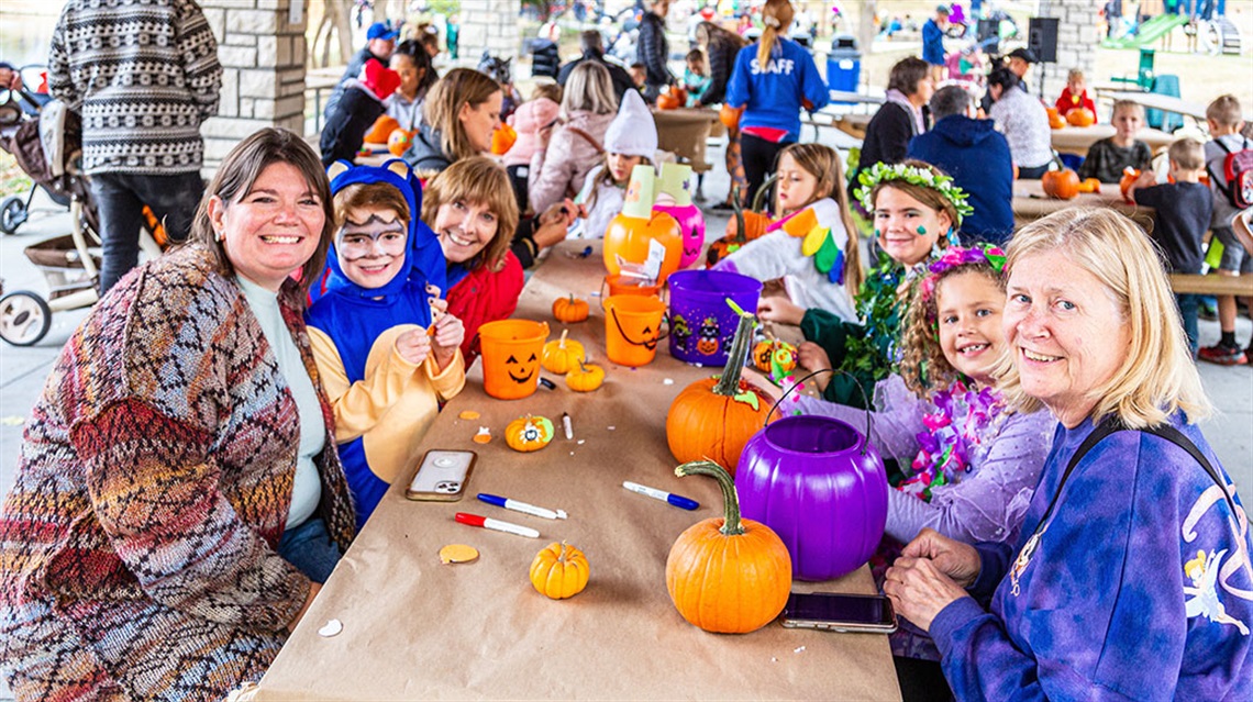 families decorating pumpkins