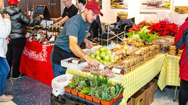 JET Produce and Meats vendor booth selling vegetables