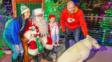 Santa Claus posing with family and dog