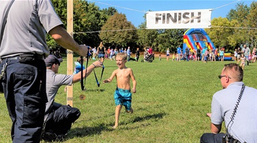 Boy runs to finish line