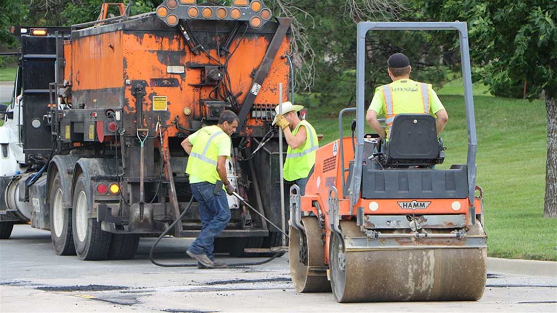 Employees repairing street