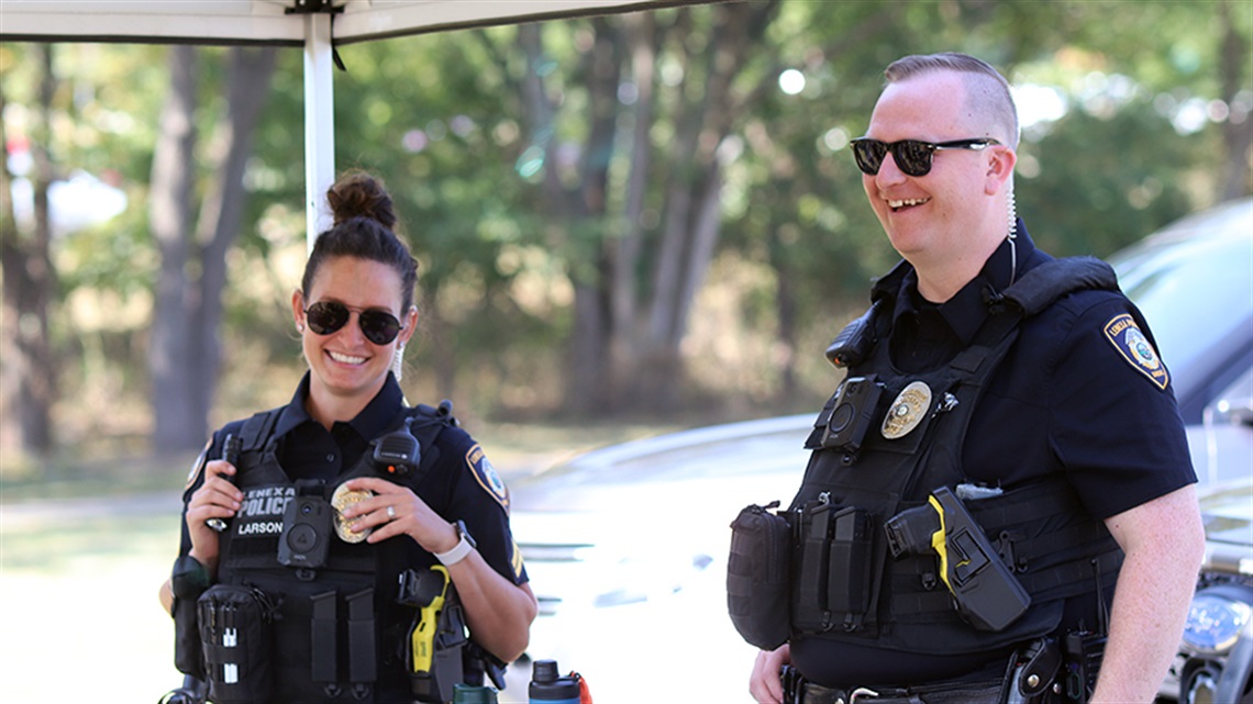 Two Police Officers in uniform smiling