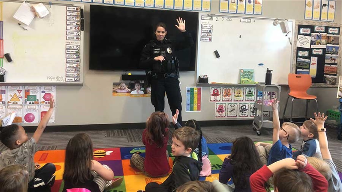 Police officer in classroom with students