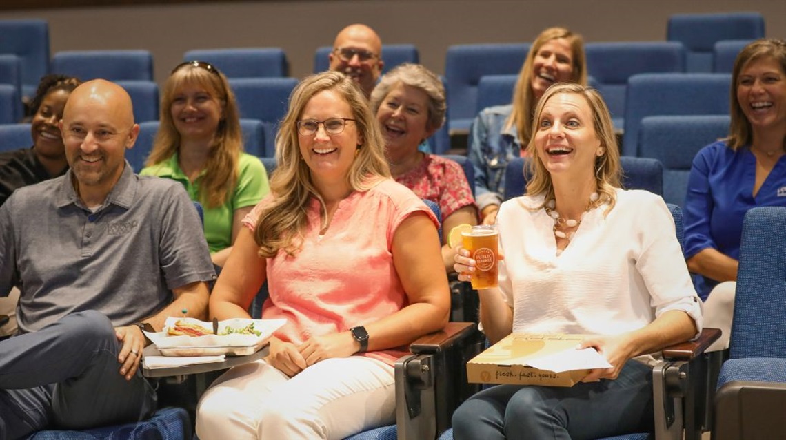 People watching performance at City Center Live with food and beverage from the Lenexa Public Market
