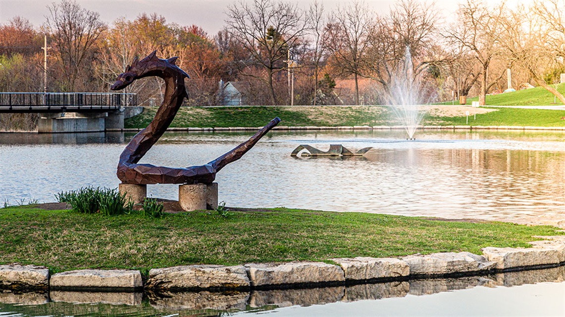 The Serpent and Swimmer public art sculptures in pond