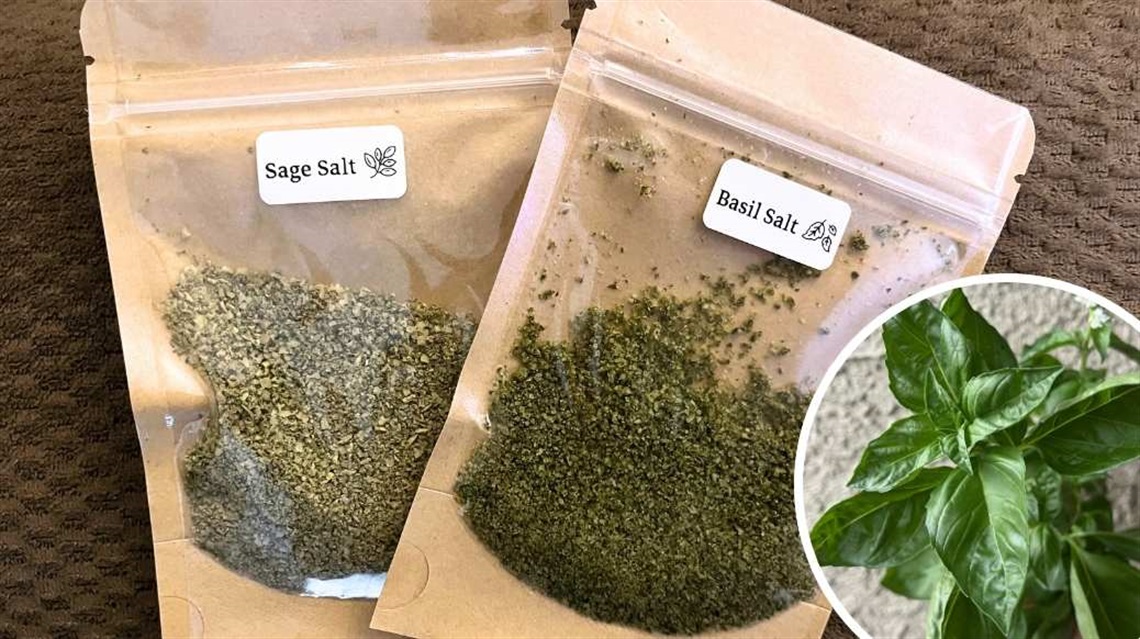 Pouches of sage salt and basil salt with overlay image of fresh basil