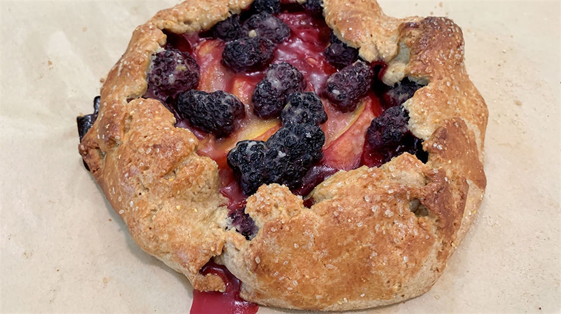 Closeup view of peach blackberry galette
