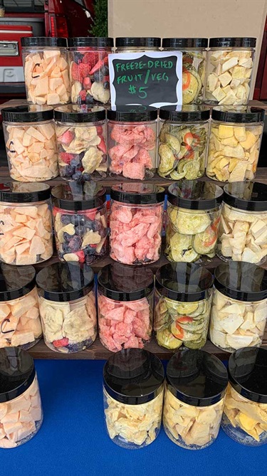 Jars of freeze-dried fruits and vegetables on display rack