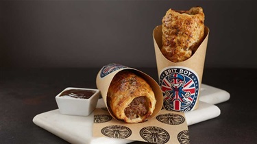 Brit Boy sausage rolls in packaging on a cutting board