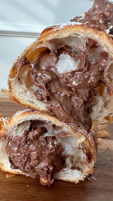 Profiterole cut in half and filled with chocolate