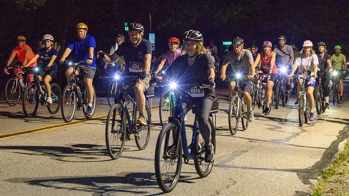 cyclists riding in group at night