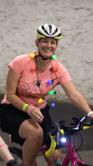 Woman cyclist with holiday lights