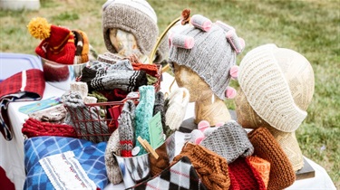 Knitted accessories on display at vendor booth
