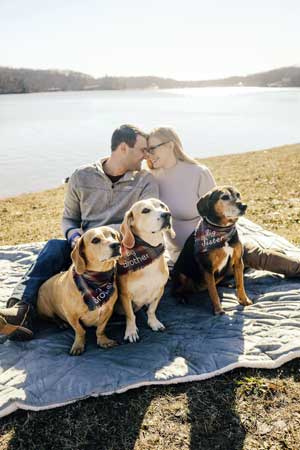 Noah and his wife with their three dogs