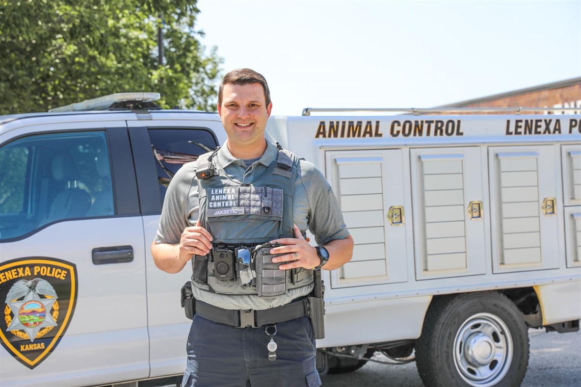 Noah standing in front of animal control vehicle