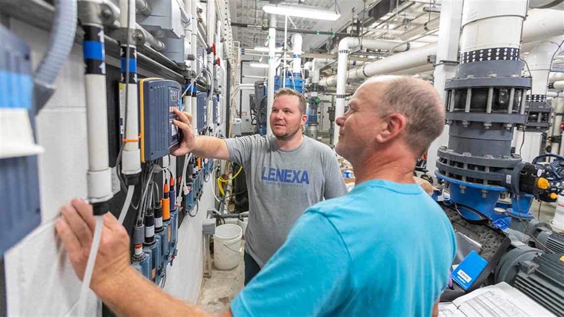 Two men looking at mechanical system