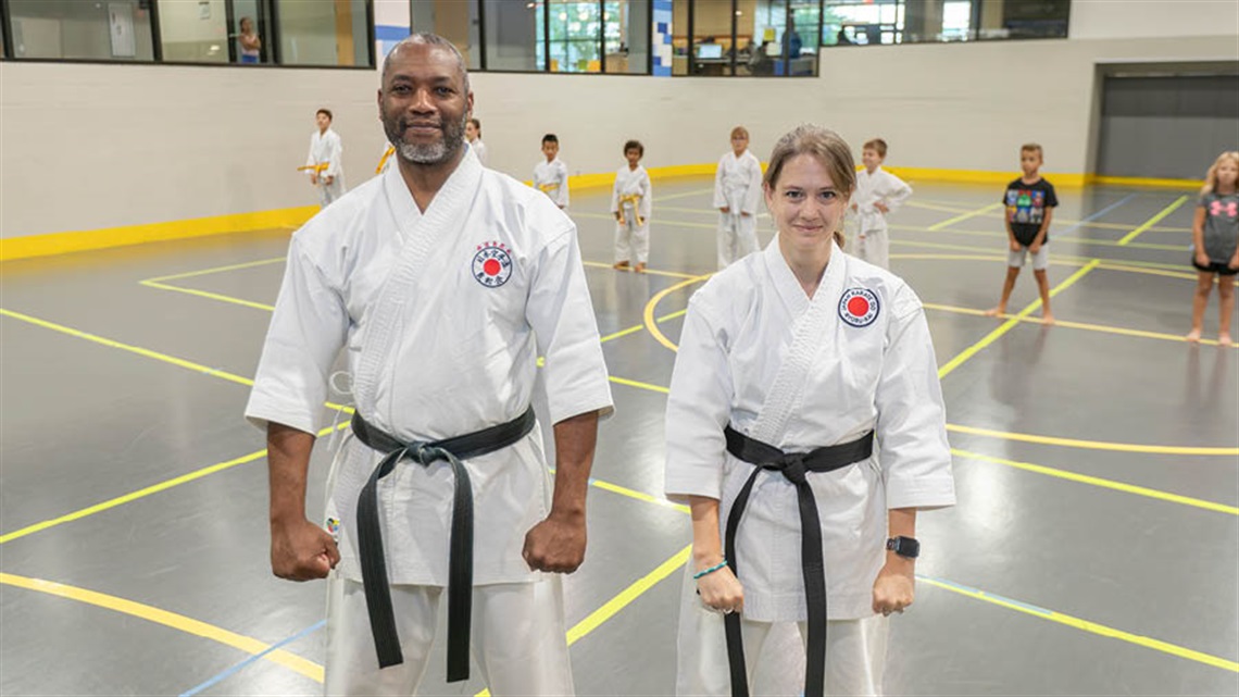 Karate instructors with students behind them