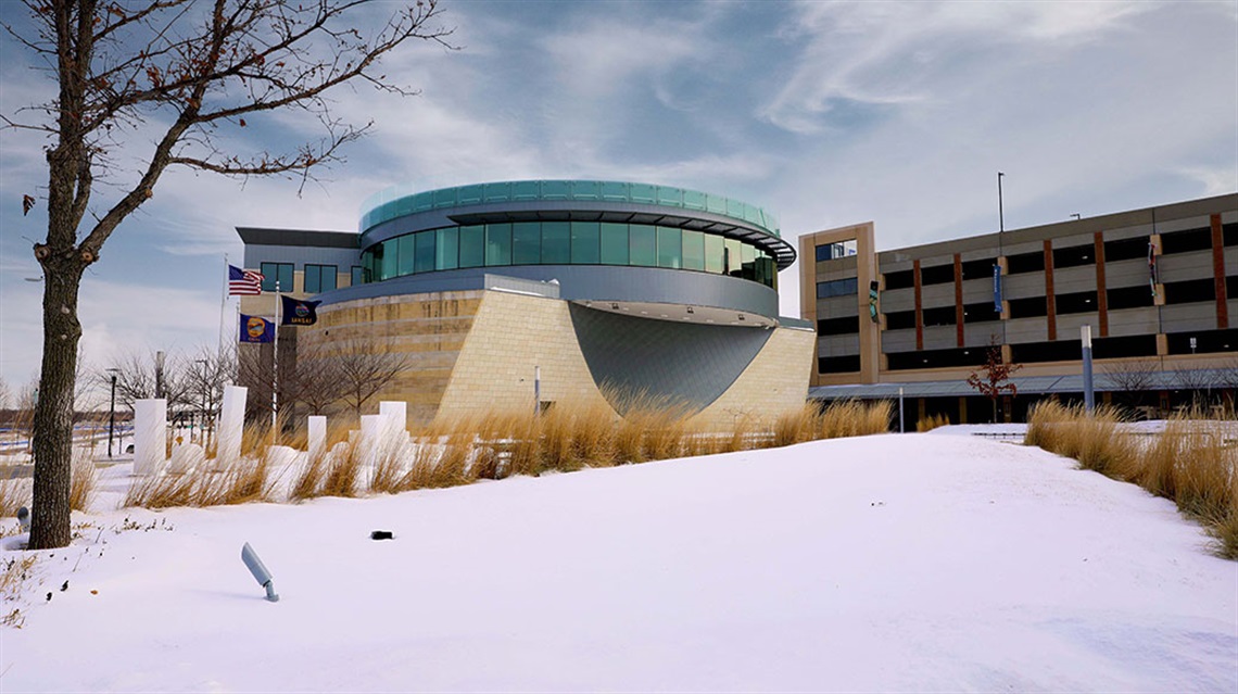 View of snowy exterior of Lenexa City Hall and parking garage