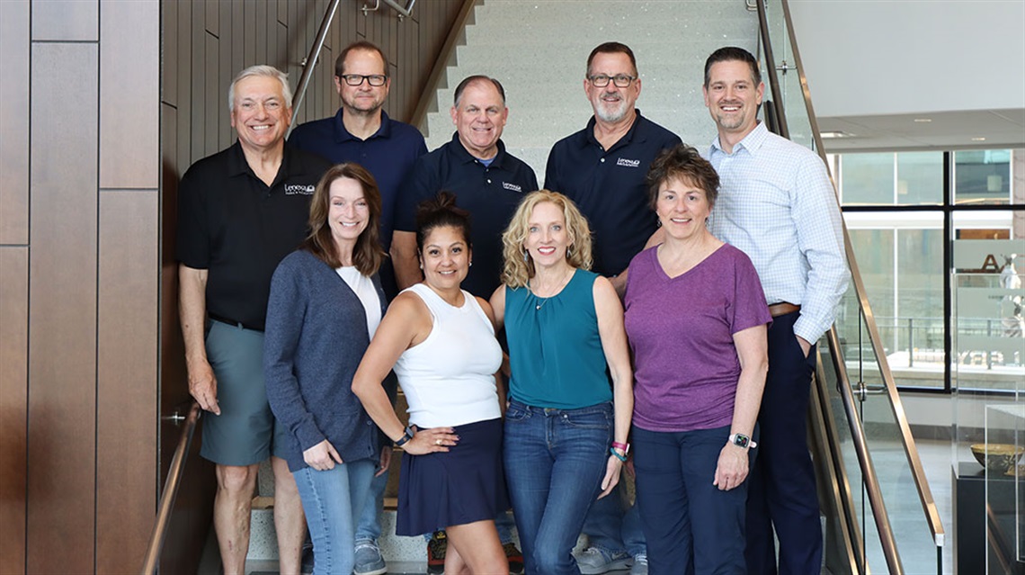 Nine Park & Recreation Advisory Board members pose on staircase