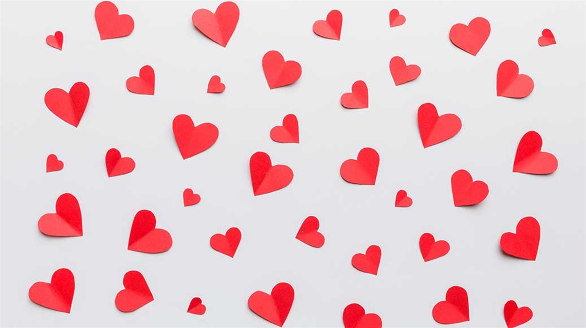 Lots of folded paper red hearts in different sizes