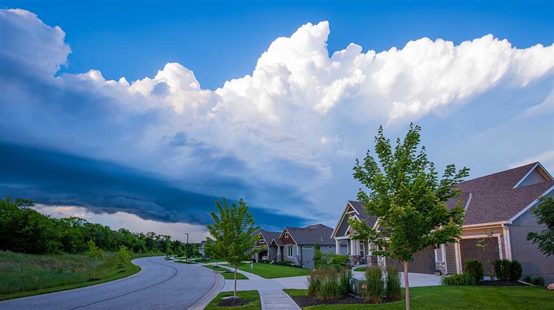 Storm clouds rolling in over residential street of houses