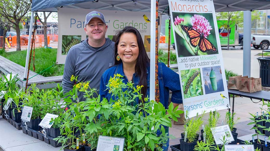 Smiling man and woman at native plant vendor booth