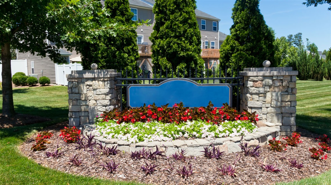 Entry sign with landscaping in a neighborhood