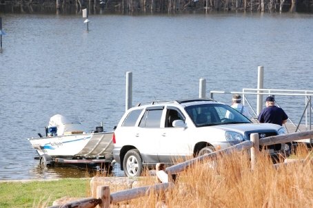 Vehicle unloading a boat at a dock