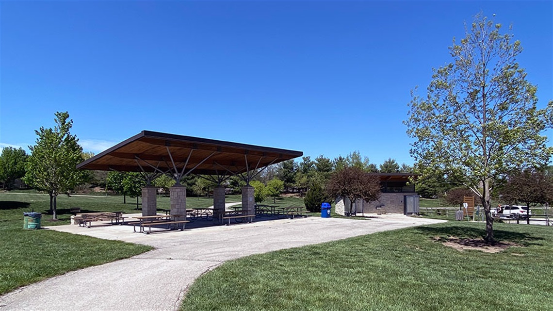 Trail alongside shelter with picnic tables