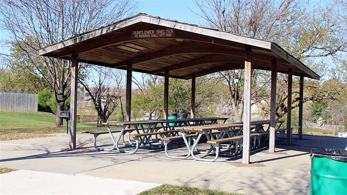 Park shelter with picnic benches, trashcans and grill