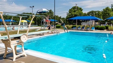 Kid diving into Flat Rock Creek Pool from diving board