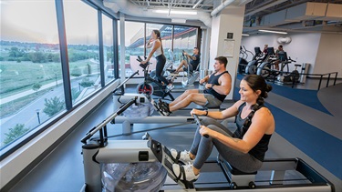 Patrons using rowing machines and other cardio equipment