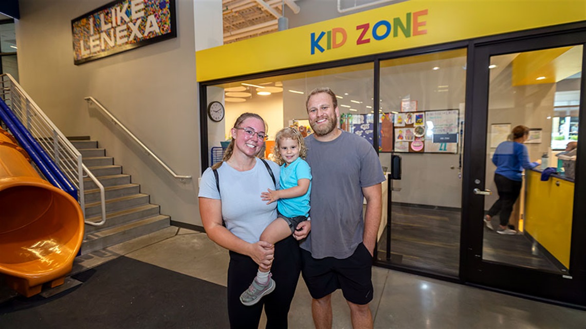 mother, father and child outside of Kid Zone