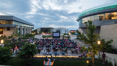 Crowd watching movie on Lenexa Commons at dusk