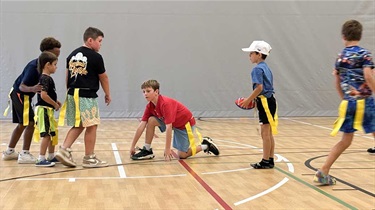 Group of boys playing flag football in gym