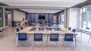North and south sections of room facing north, with tables and chairs set up