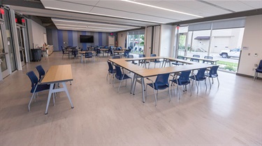 North and south sections of room facing northeast, with tables and chairs set up