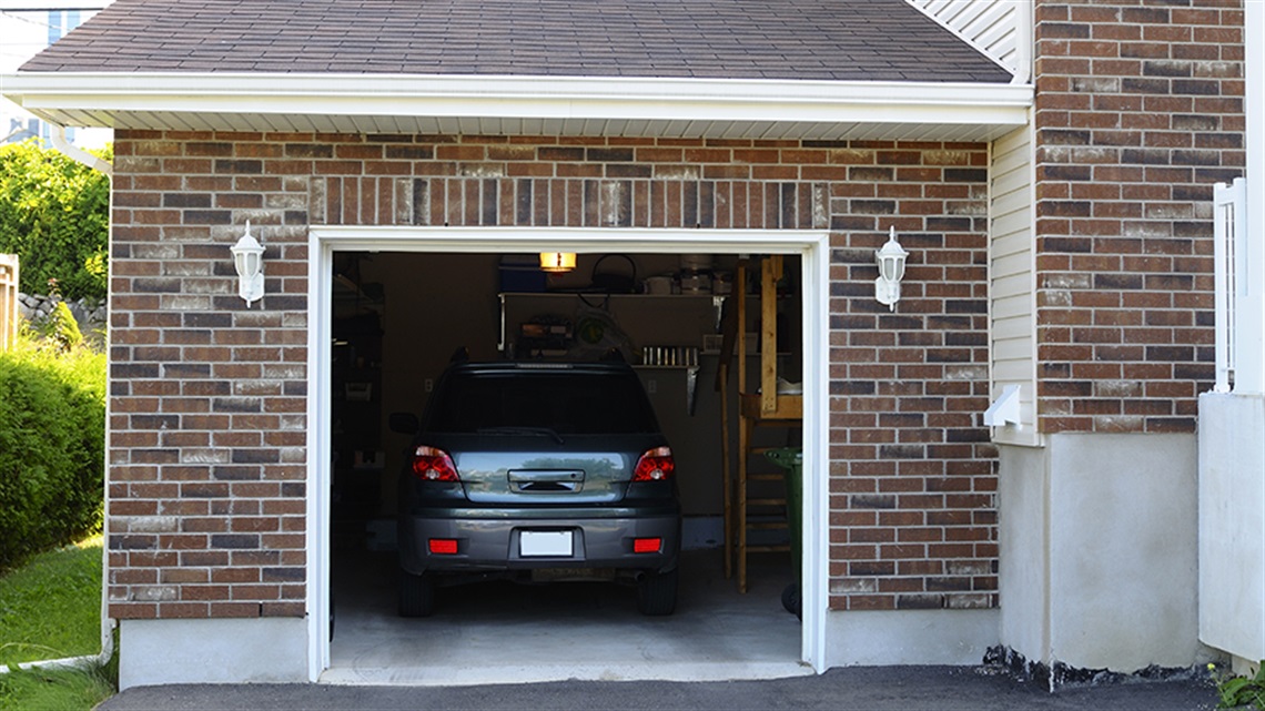 Car parked in garage with garage door open