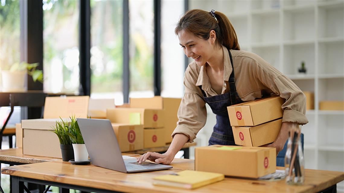 Woman working at home with packages