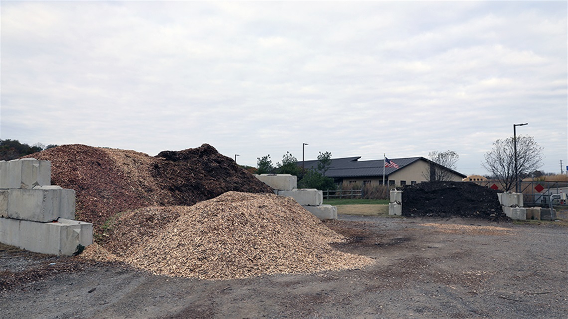 piles of different colored mulch in front of building
