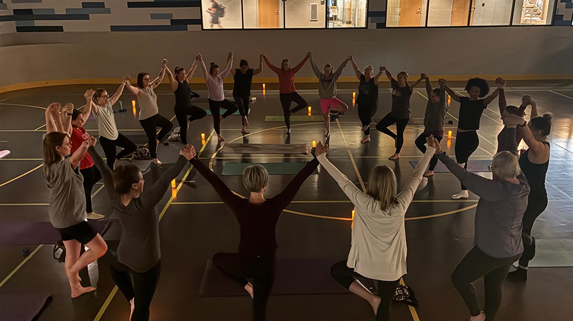 three women stretching on yoga mats