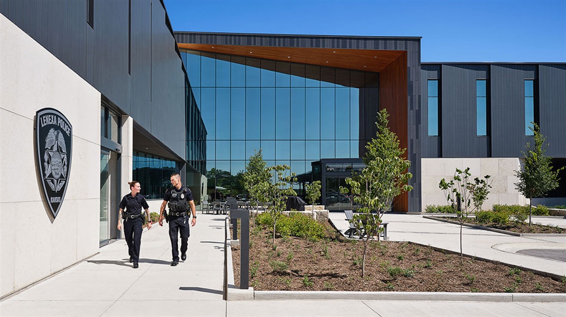 Female officer giving a tour of the police station to a group of kids