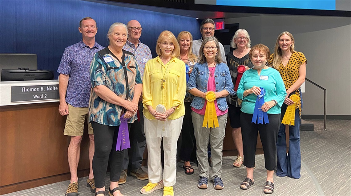 group of winning artists holding ribbons