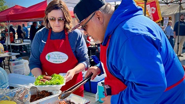 Man and woman plating chicken wings for competition judging