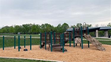Playground with park shelter in background